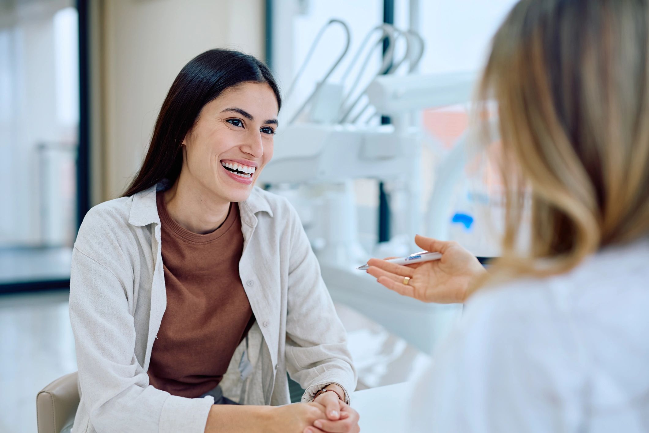 Patient consulting with a dentist in a modern dental clinic
