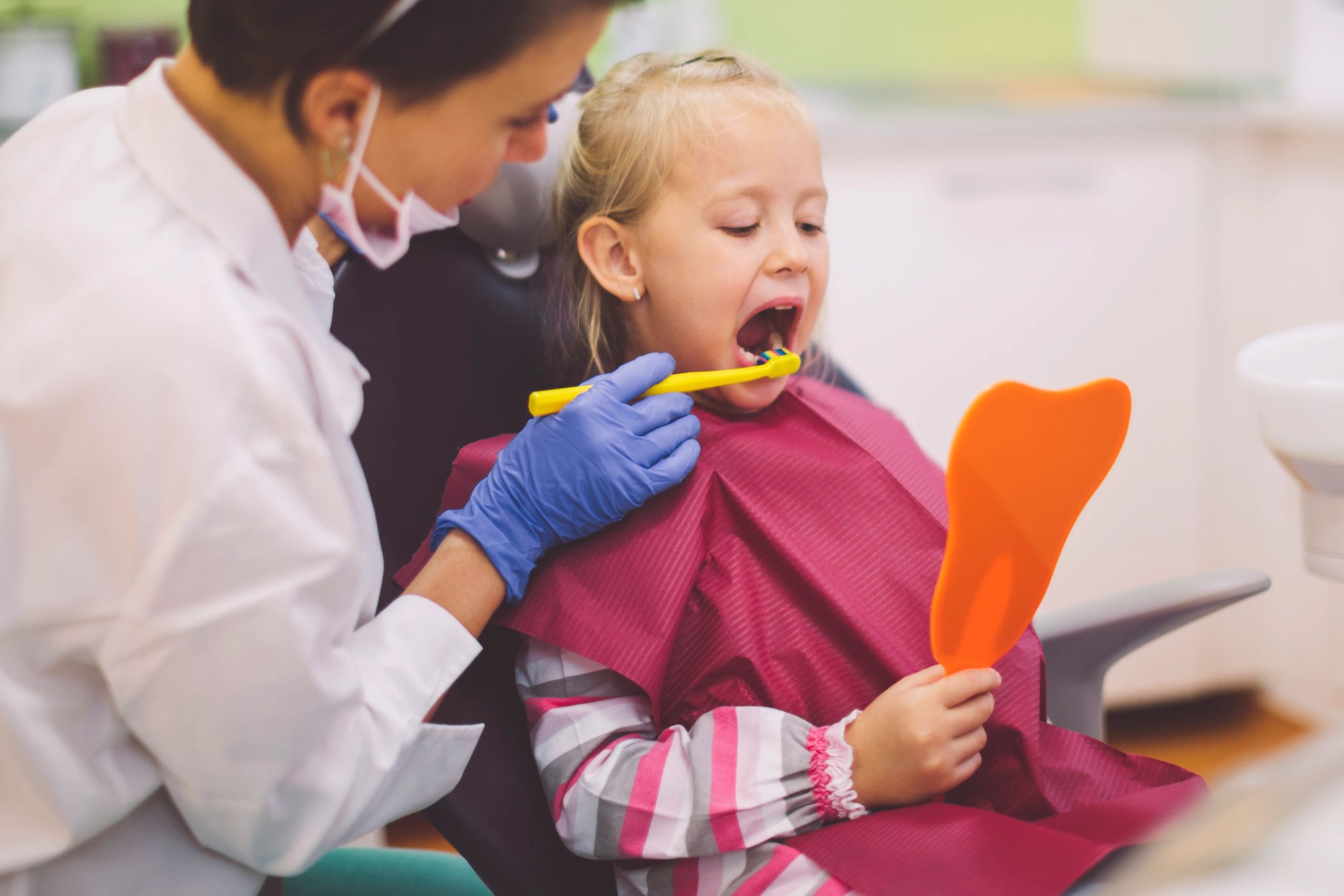 Dental hygienist performing a teeth cleaning