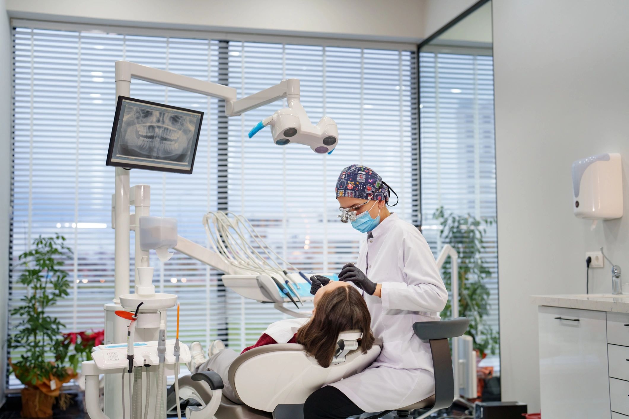 Dental cleaning and checkup with dentist and patient in clinic