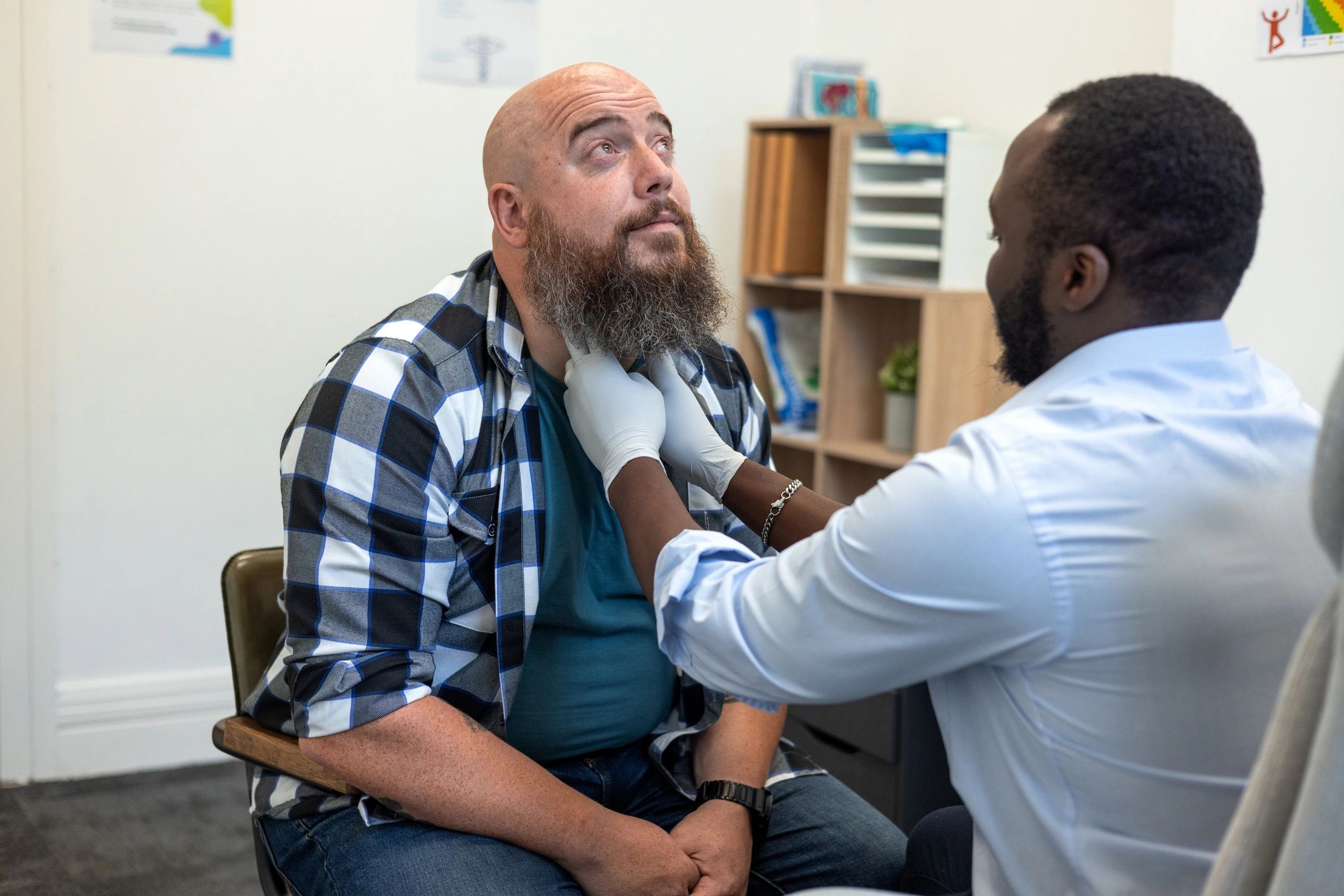 Doctor examining patient during consultation