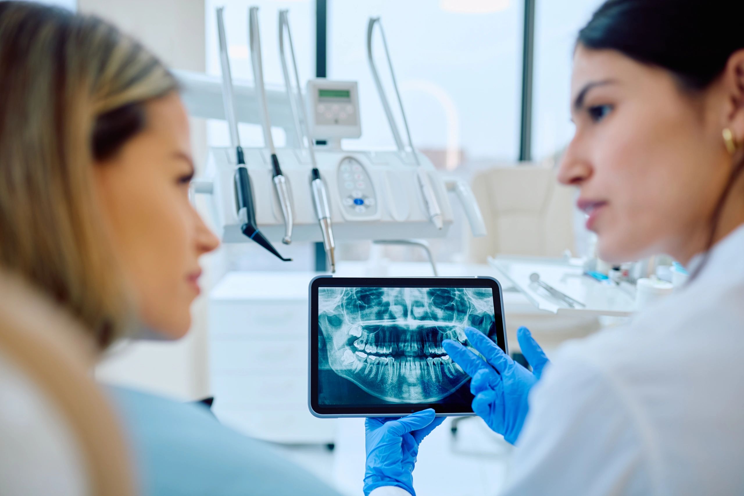 Dentist explaining dental X-rays during a bridge consultation