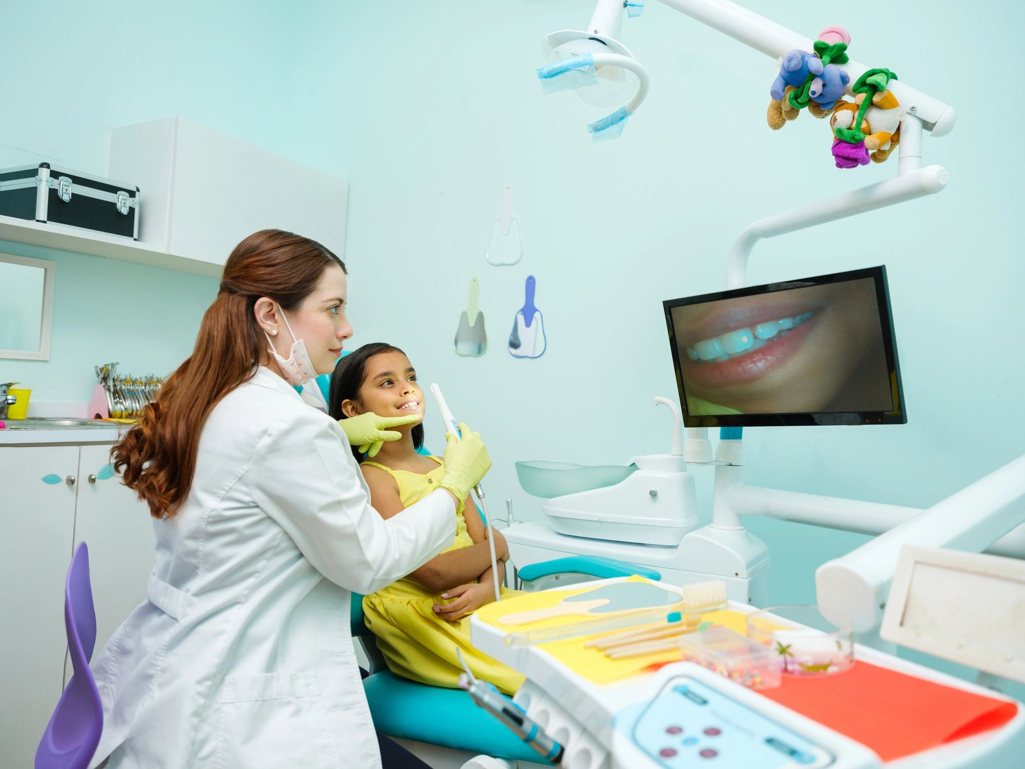 Dentist using digital scanning technology with a patient