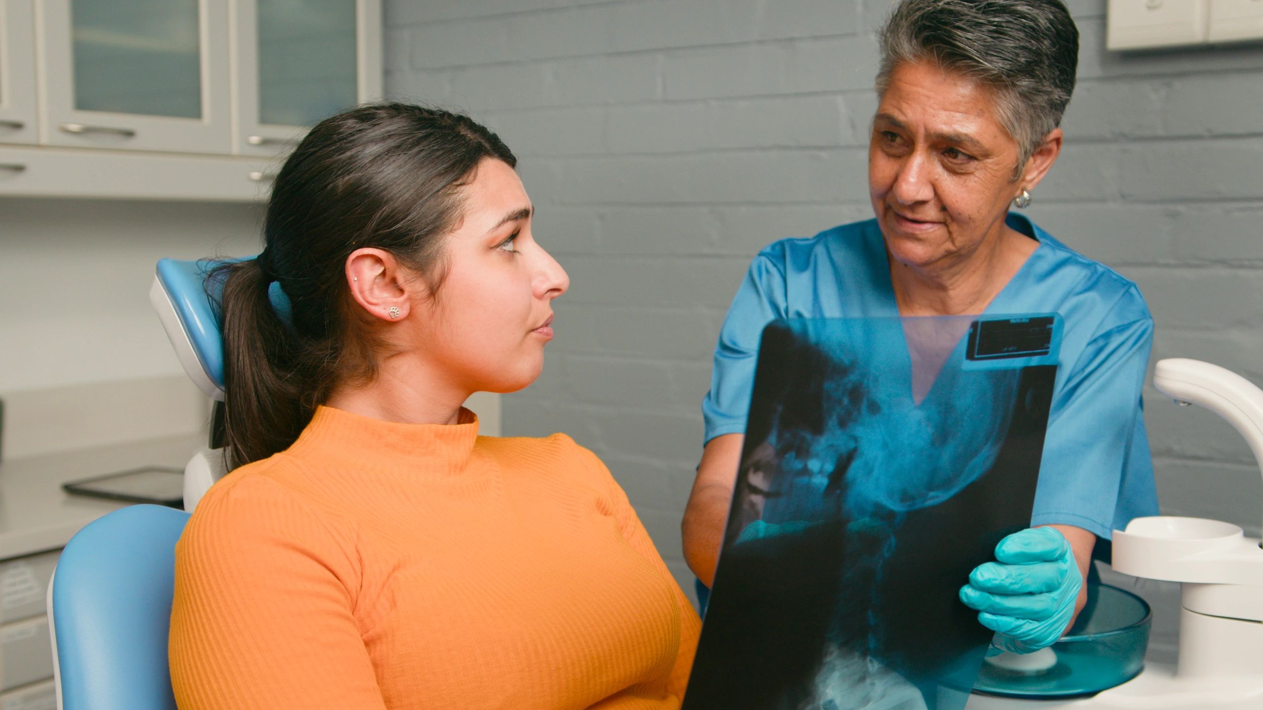 Dentist reviewing digital dental information with a patient